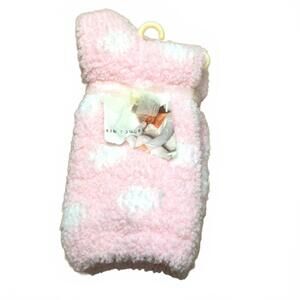 Pink fuzzy socks with white polka dots